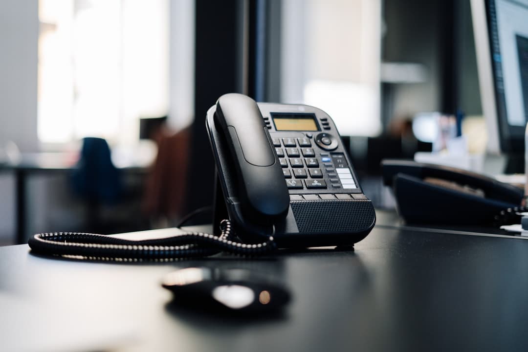 Phone on a desk — direct line to the in-house scheduling team