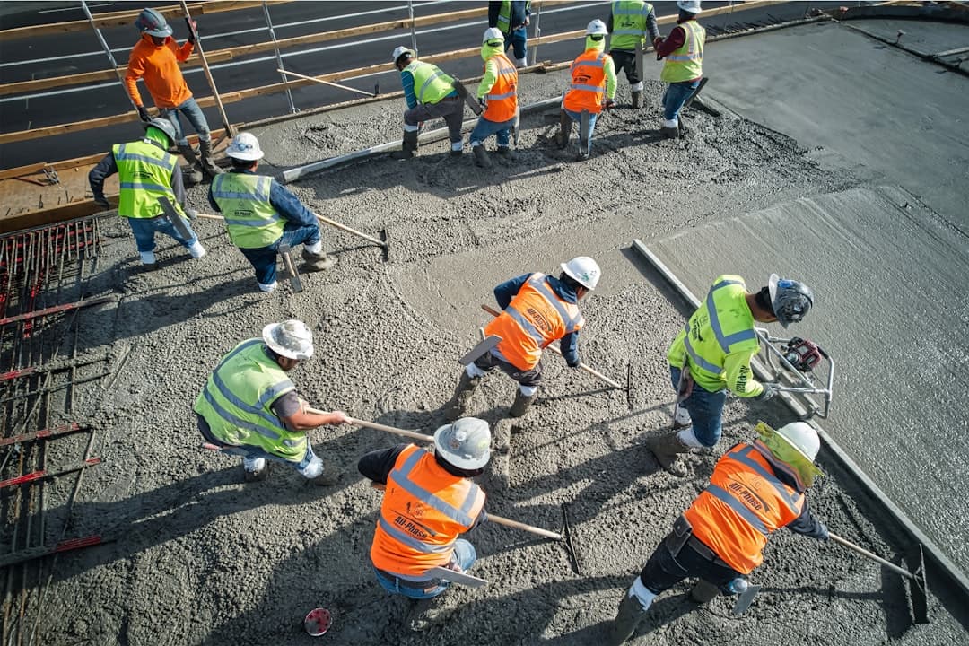 Concrete crew pouring and finishing fresh concrete